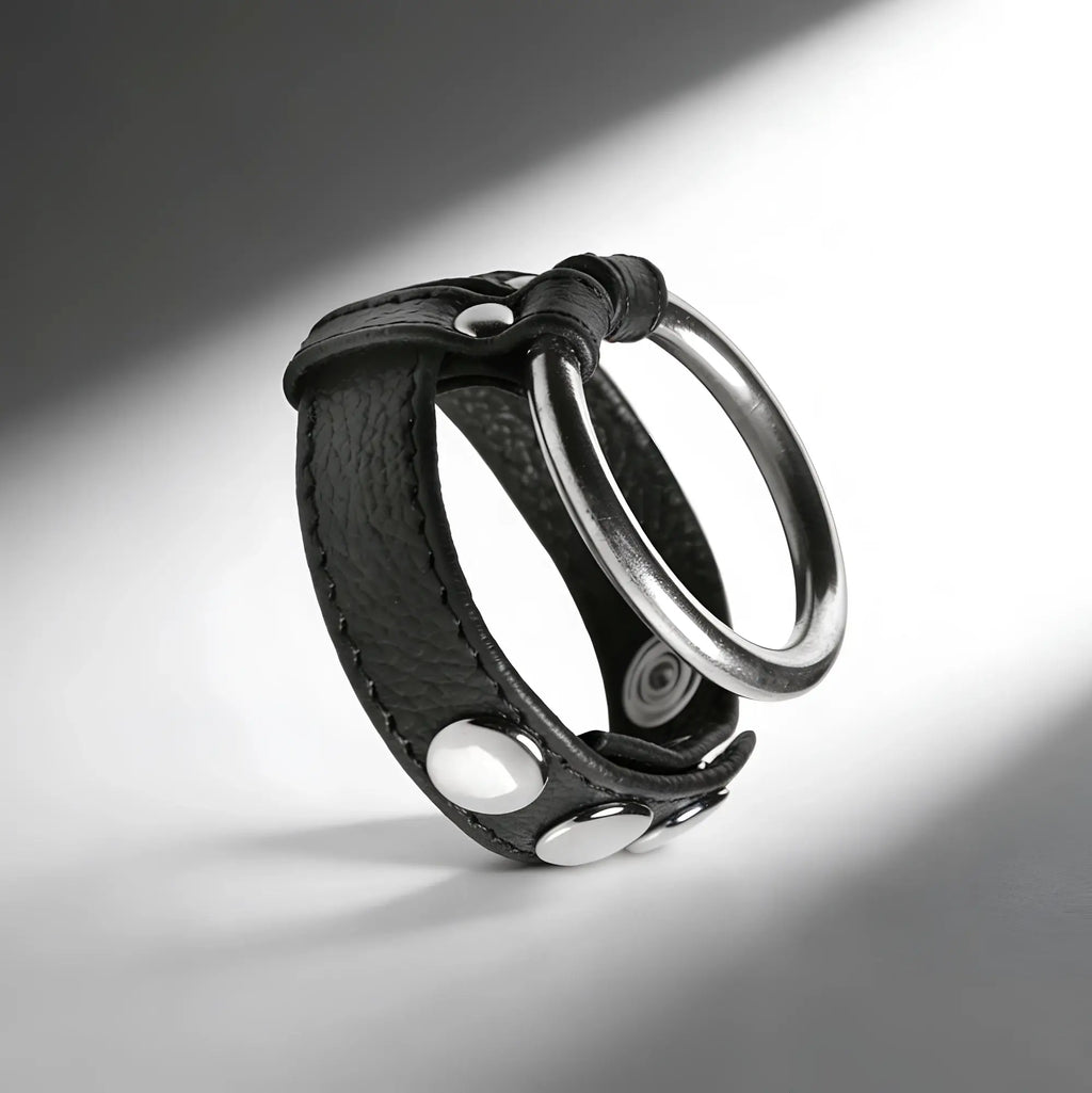 Strict Leather cock and ball ring made of black textured leather with silver metal studs and a large steel ring.