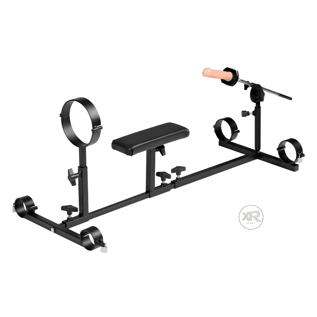 Strict Leather Stockade: Black metal frame with adjustable cuffs, central chest pad, and a protruding dildo rod.
