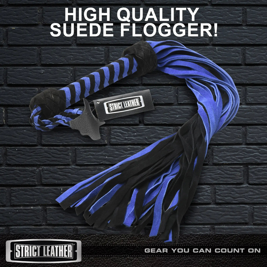 Strict Leather black and blue suede flogger with a braided handle and matching fringed tails on a black brick background.