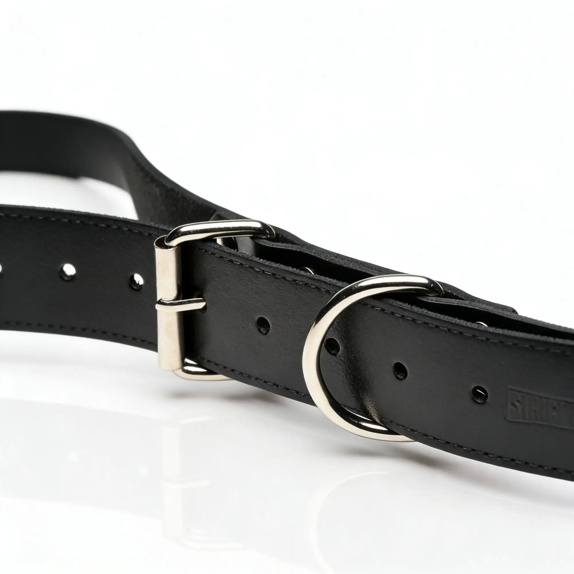 Strict Leather Thigh Sling: Black leather strap with a silver metal buckle and O-ring on a white background.