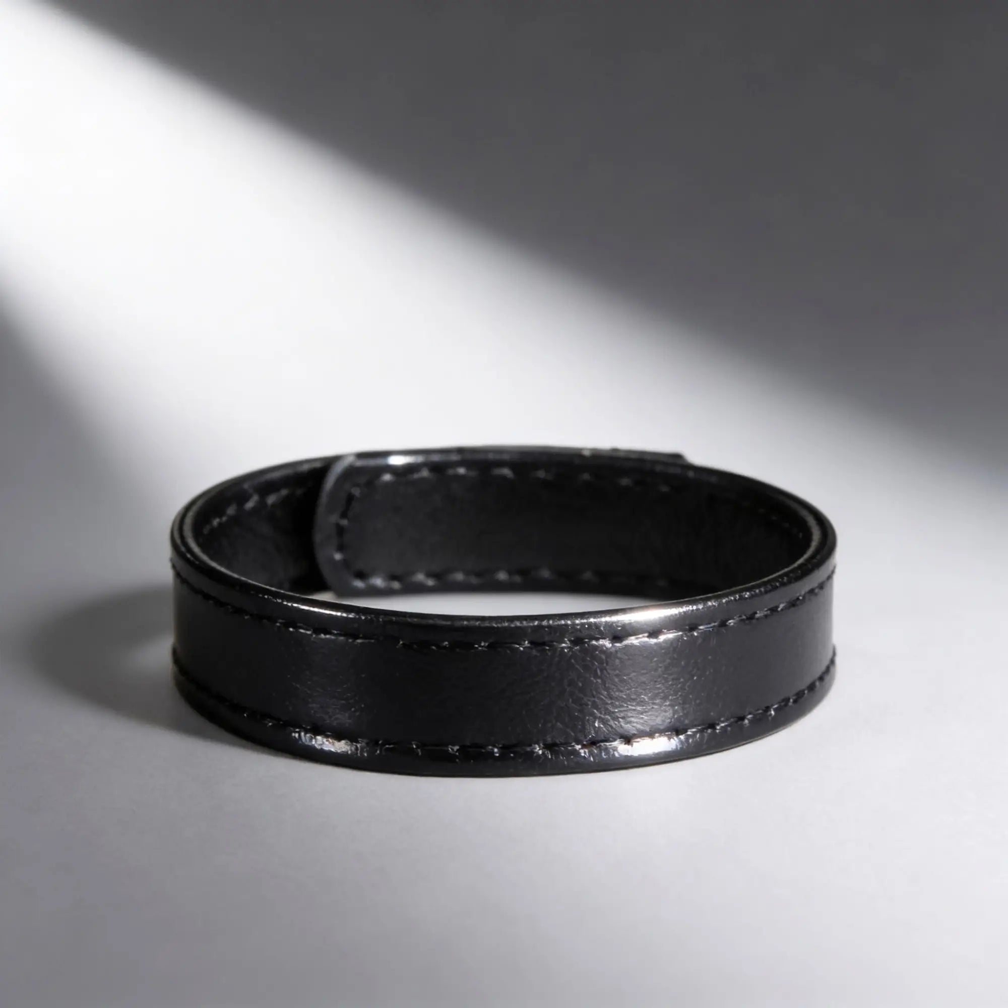 Black leather and velcro cock ring with stitched detailing.