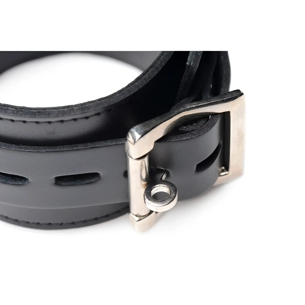 Strict Leather black leather cuff with a silver-tone metal buckle and attachment ring against a white background.