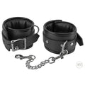 Strict Locking Padded Wrist Cuffs in black faux leather with silver-tone metal buckles and a detachable chain link.
