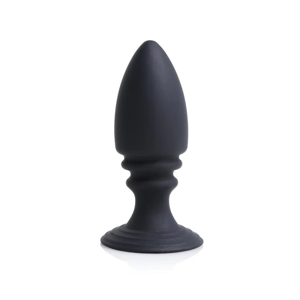 Strict Male Chastity Harness matte black silicone anal plug with a tapered tip and flared base against a white backdrop.