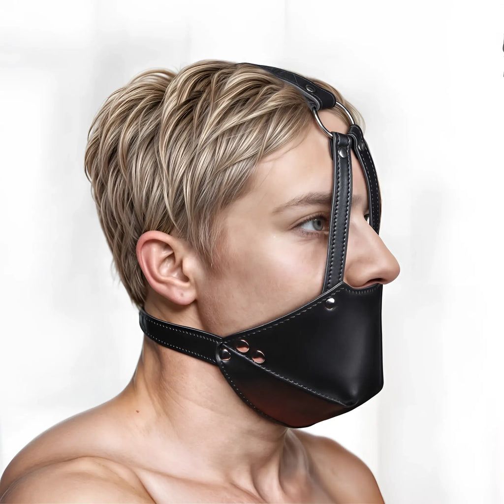 Strict Muzzle Harness with black leather, featuring adjustable straps, metallic rivets, and an integrated ball gag.