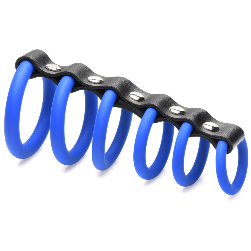 Strict Silicone Gates of Hell chastity device featuring six blue silicone rings linked by a black strap with metal studs.