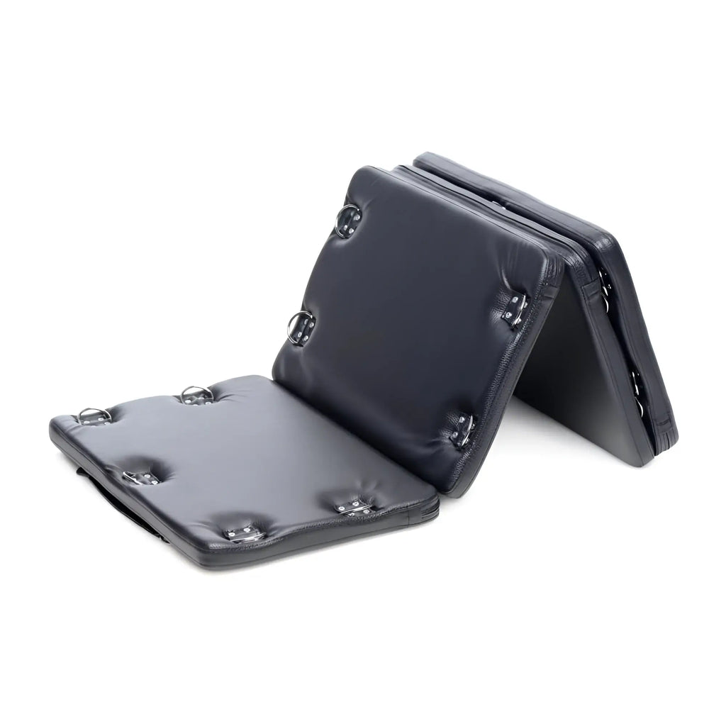 Strict XL Bondage Board: A foldable, black padded board featuring multiple metal D-ring attachment points.