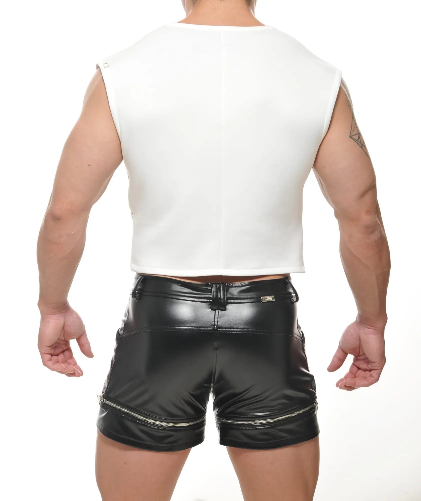 Back view of black patent leather shorts with zipper accents and central back belt loop for edgy style