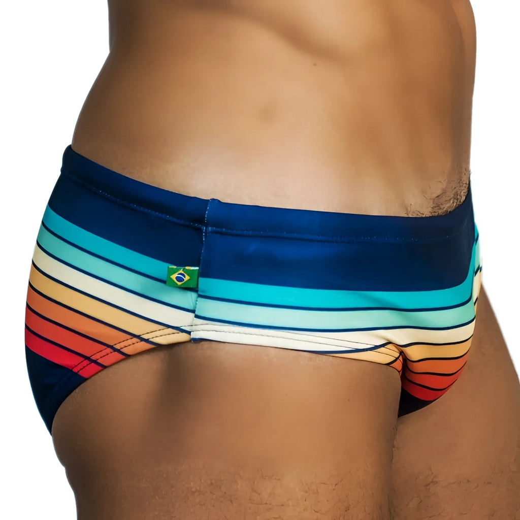 Sunset sunga mens designer swimwear with vibrant navy blue teal white orange and red striped trunks and brazilian flag patch