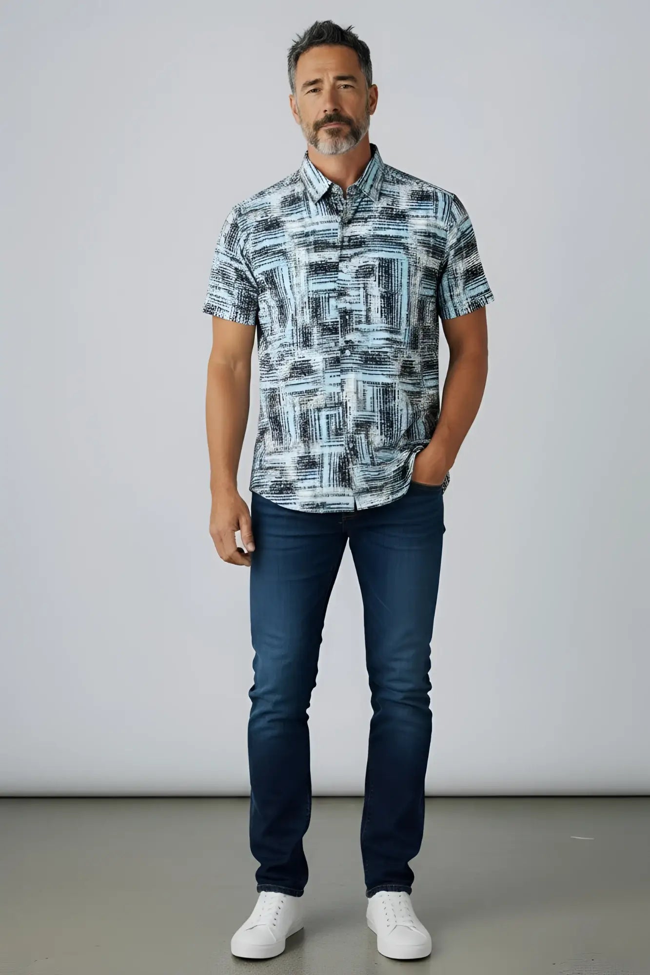 A man wearing a suslo crinkled fabric short-sleeved shirt with an abstract gray and white geometric pattern