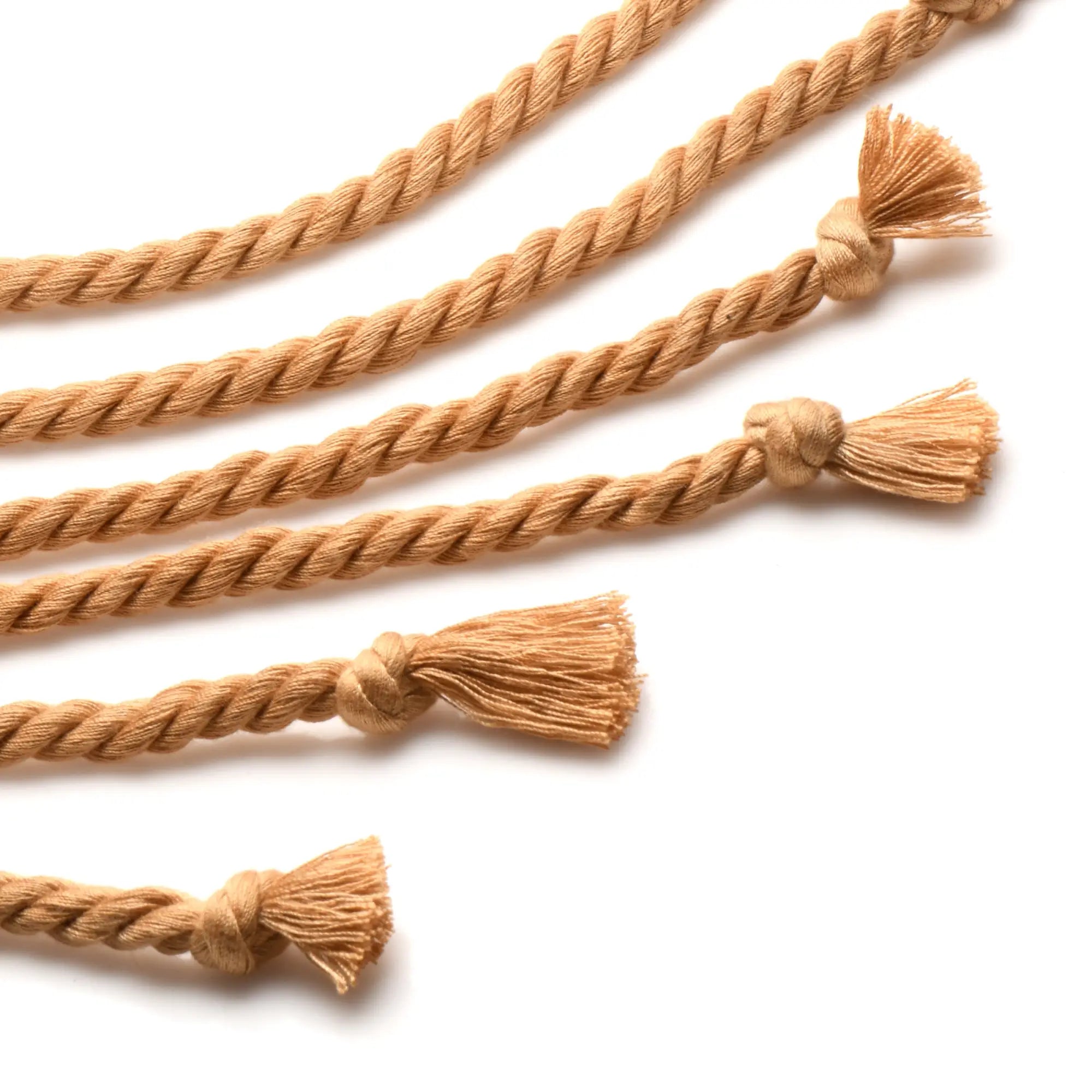 Tan braided rope flogger with frayed tassels at each end for swashbuckler style impact play