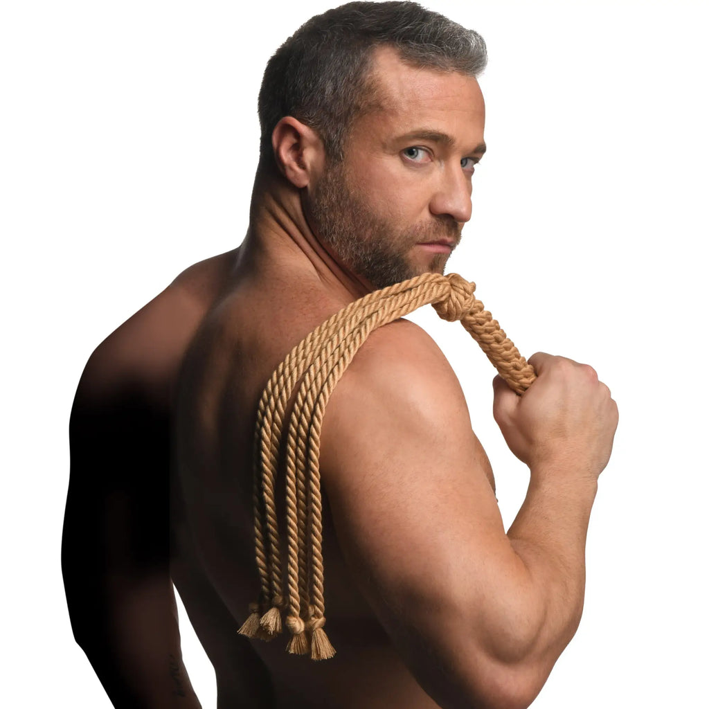 Tan braided rope flogger with tassels designed for swashbuckler inspired impact play and sensory stimulation