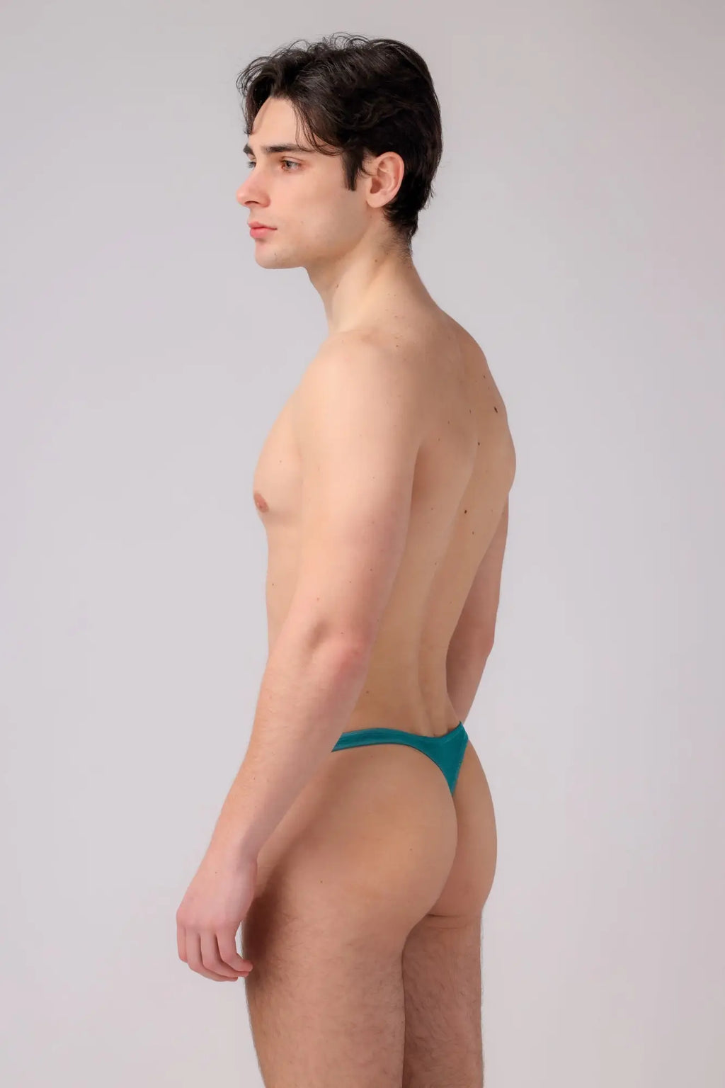 Teal-colored as sweet tulle thong made of smooth stretchy fabric shown from the back side