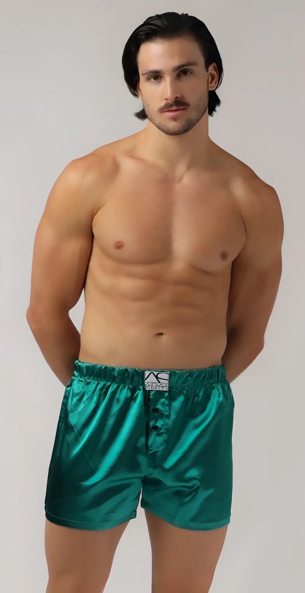 Shiny emerald green satin sweetheart boxer shorts with a white label at the waistband for stylish comfort