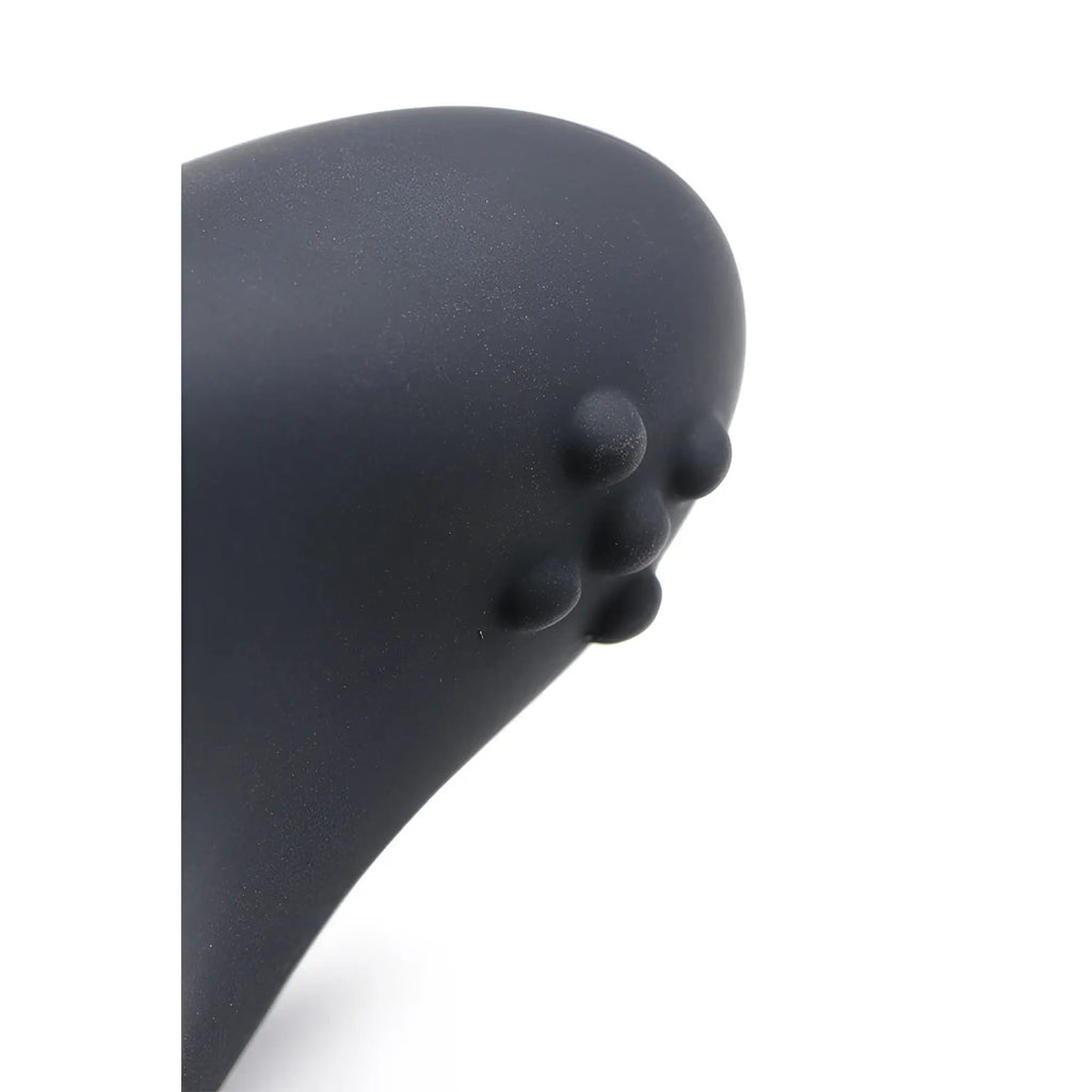 Close-up of the black matte Swell 10X silicone prostate plug, showing its curved shape and textured beaded surface.