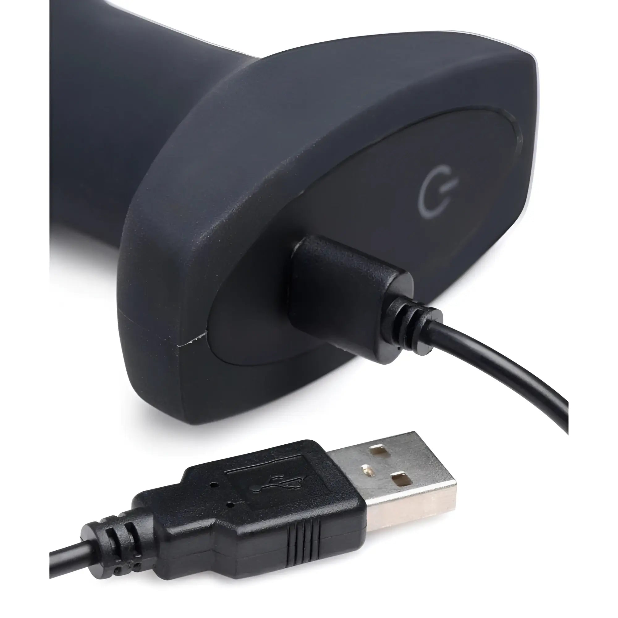 Swell silicone vibrating anal plug shown with its base connected to a black USB charging cable against a white background.