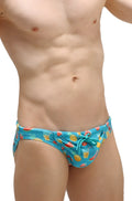 Bright blue swim bikini taik punta with a playful pattern of pineapples watermelons and tropical drinks