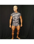 Muscular model wearing a fitted leopard print short-sleeved shirt and matching shorts by Arroyman showcasing a bold design.
