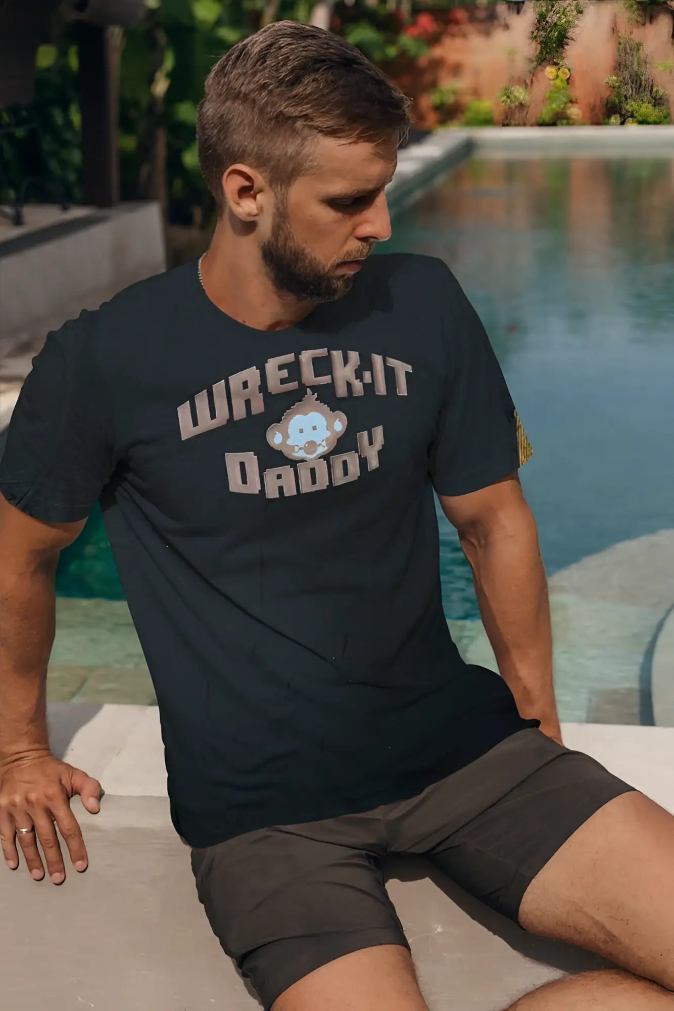 Black cotton t-shirt wreck-it with beige and light blue text and a cartoon monkey graphic on the front center