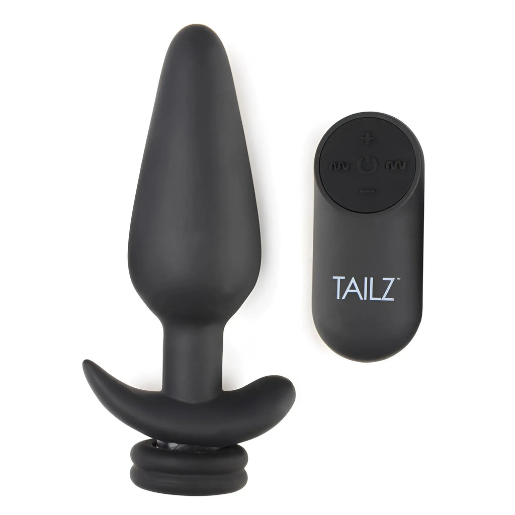 Black Tailz silicone anal plug with a T-bar base, paired with a matching remote control on a white background.