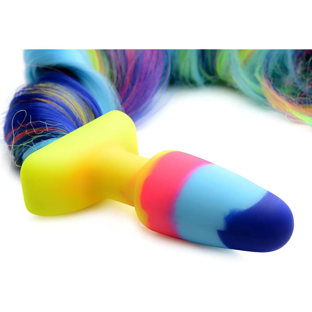 Tailz Rainbow Unicorn Tail Anal Plug featuring a yellow silicone base and a multi-colored, flowing synthetic tail.