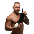 A shirtless man holds a black vibrating anal plug with a fluffy black and white fox tail.