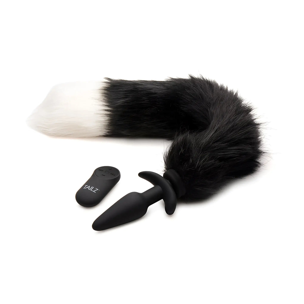Tailz vibrating anal plug with a black and white faux-fur fox tail and remote control on a white background.