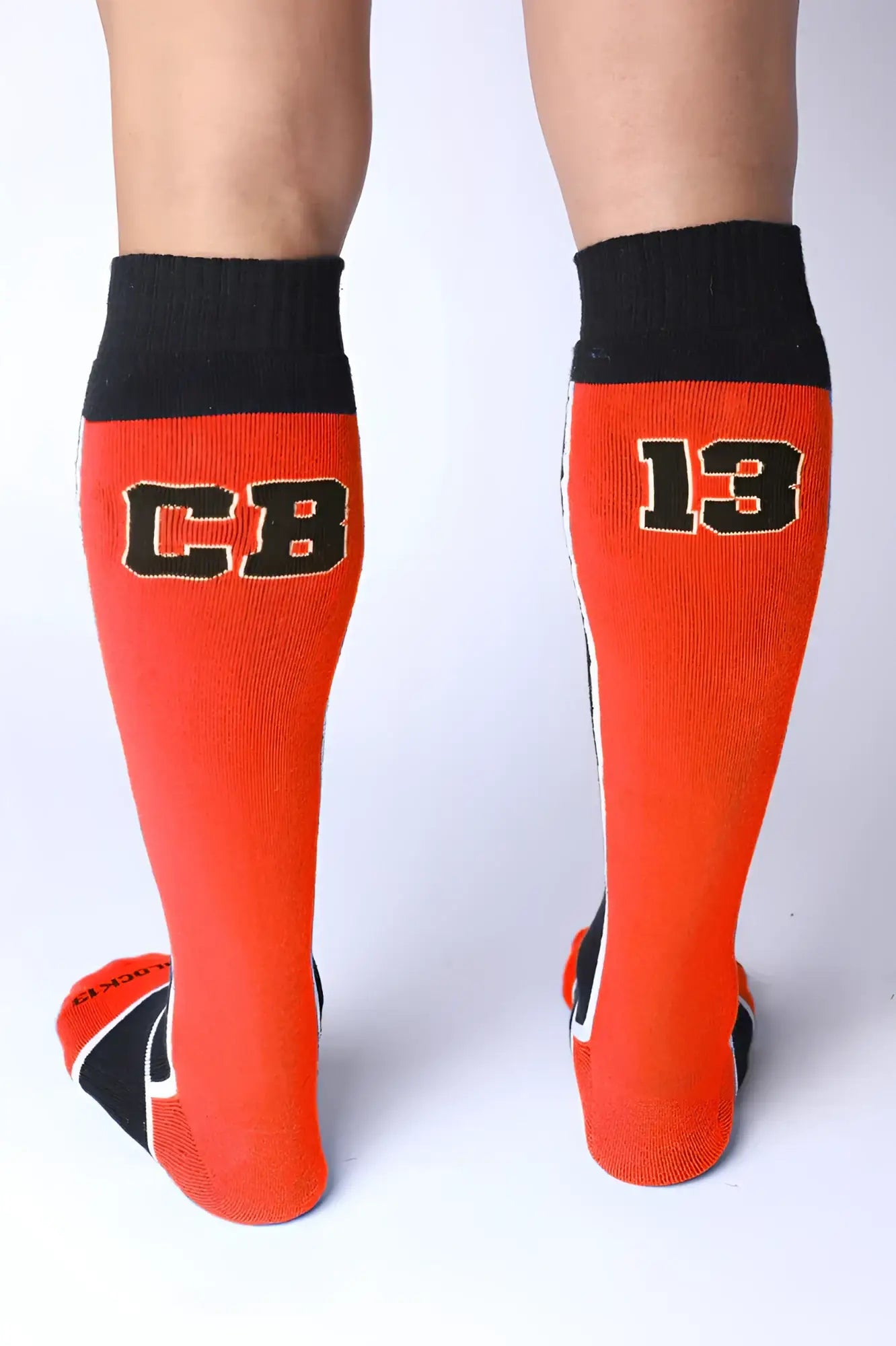Take down knee high socks in bright orange with black ribbed cuffs toe accents and bold cb and 13 lettering