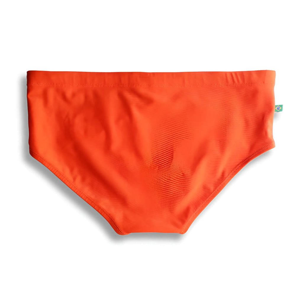 Bright orange tangerine solids men’s swimming sunga with smooth stretchy fabric and a small green side tag for beachwear