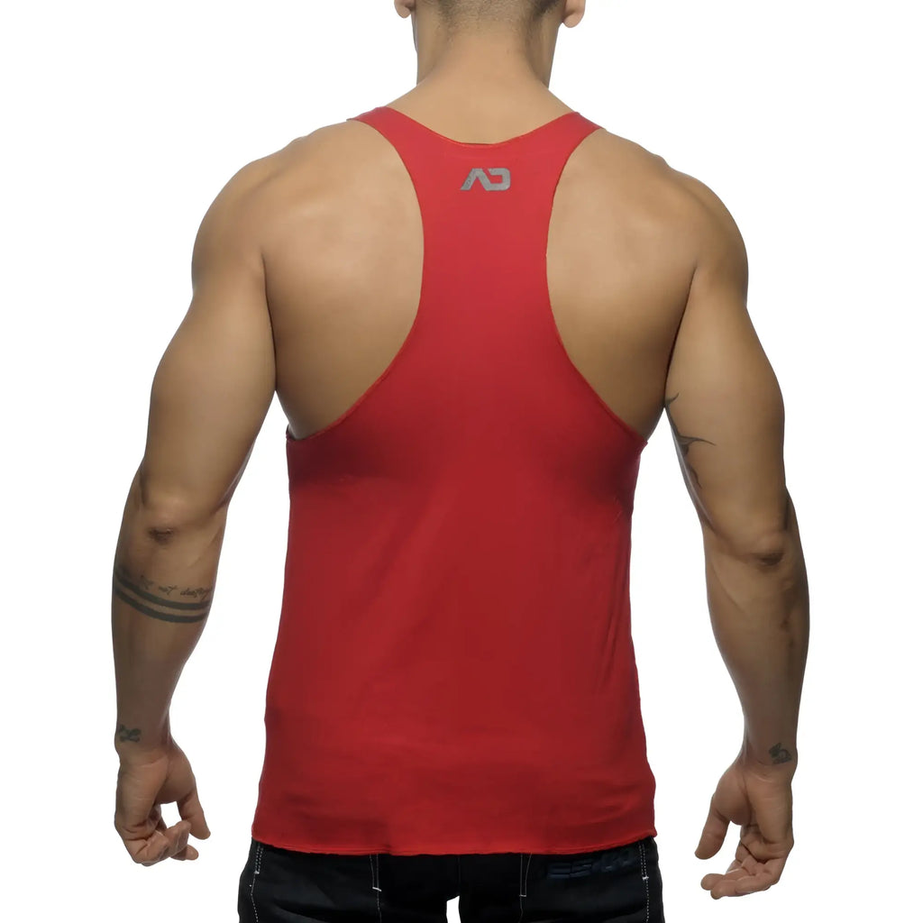 Back view of red athletic tank top with small gray logo printed on the upper back designed for activewear use