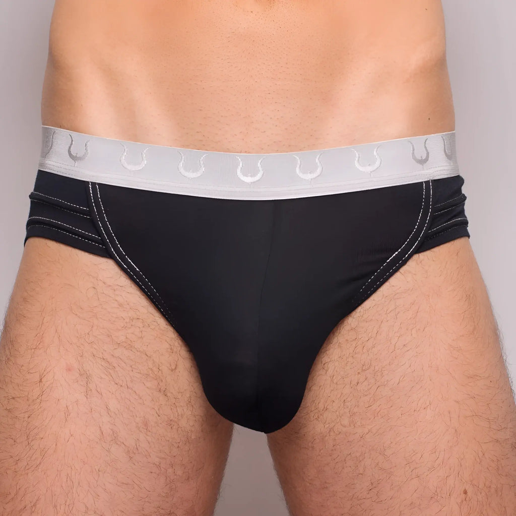 Black Tartarus Rio brief with silver horseshoe waistband and white stitching along black fabric edges