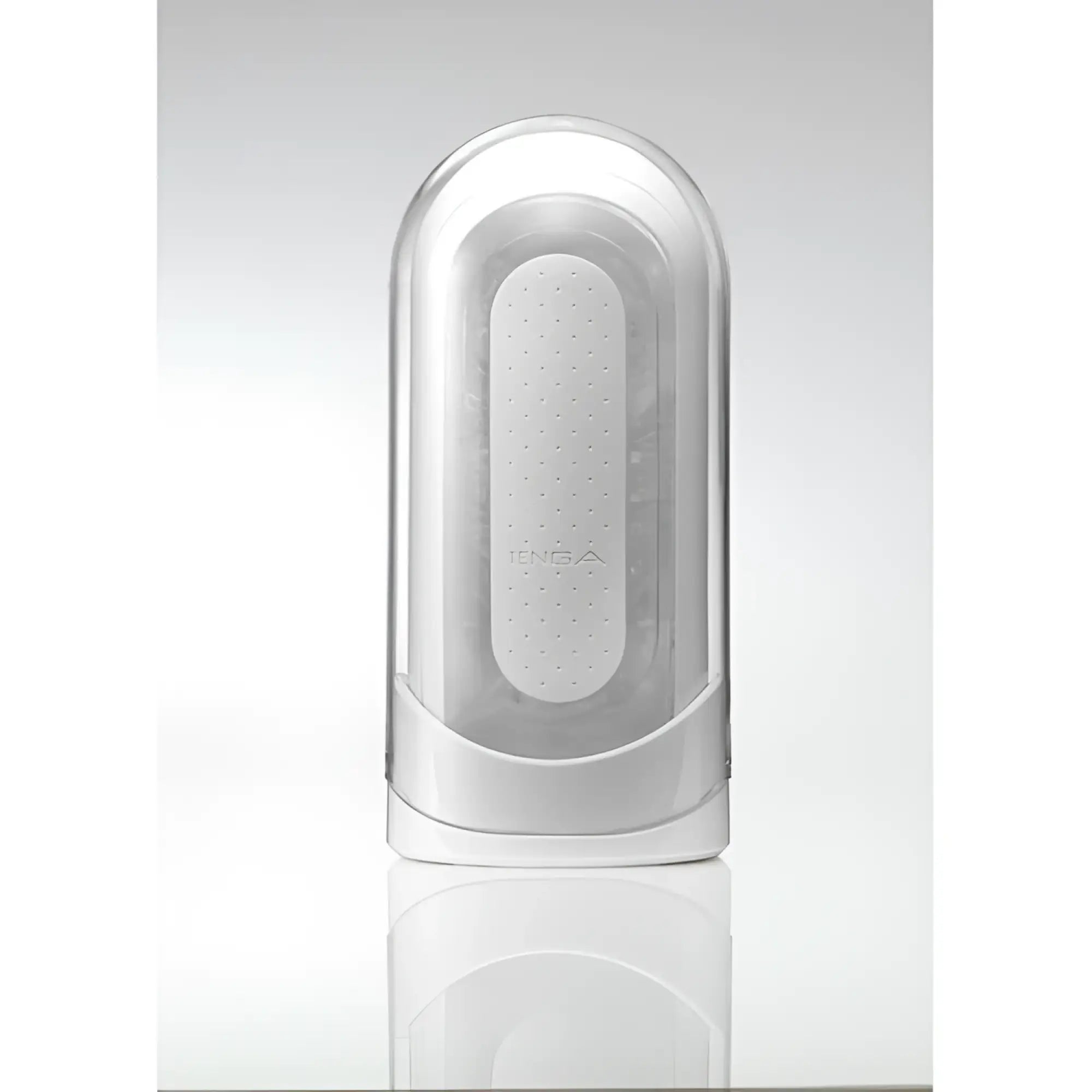Tenga Flip 0: A white, arched, reusable sleeve inside a sleek, transparent, and opaque white plastic storage case.