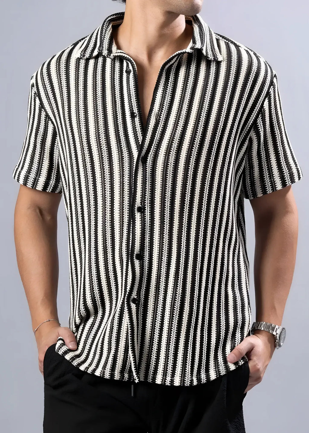 Black and white vertically striped short-sleeved button-up shirt with a textured knit pattern for casual wear