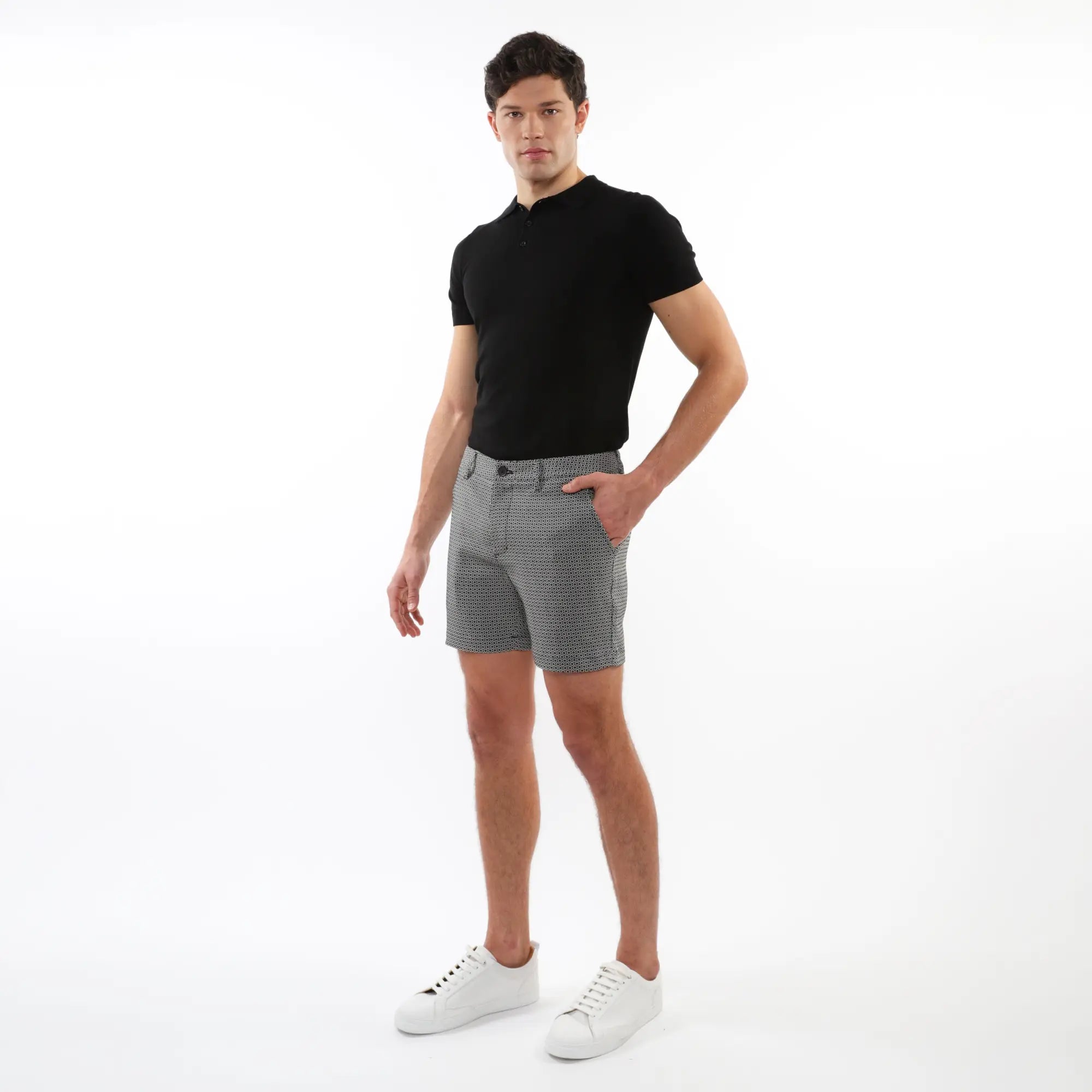 Men’s black short-sleeved polo shirt paired with textured jacquard stretch chino shorts for casual wear