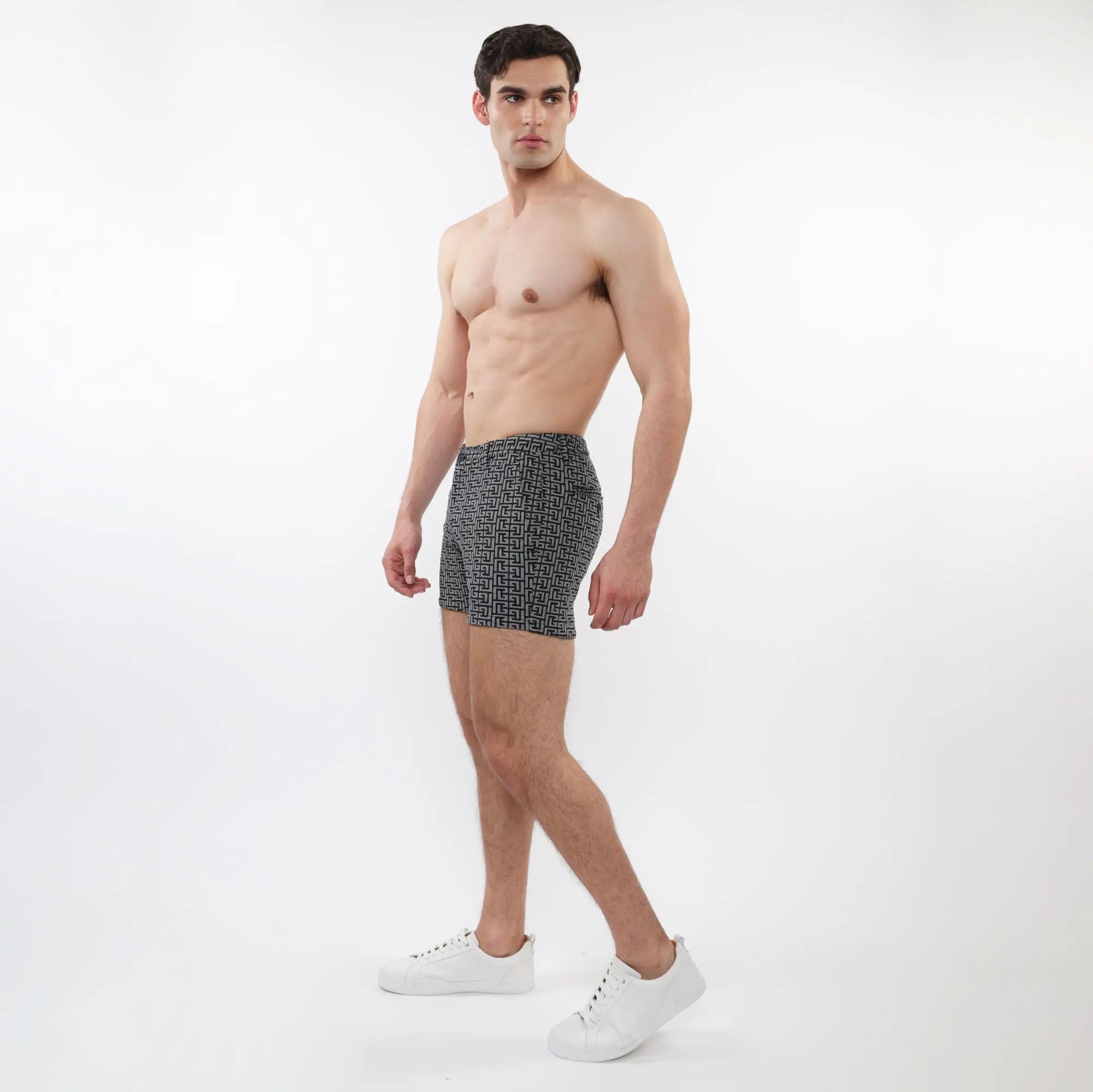 Black and white geometric-patterned men’s boxer briefs made of textured jacquard stretch knit fabric with zip pockets