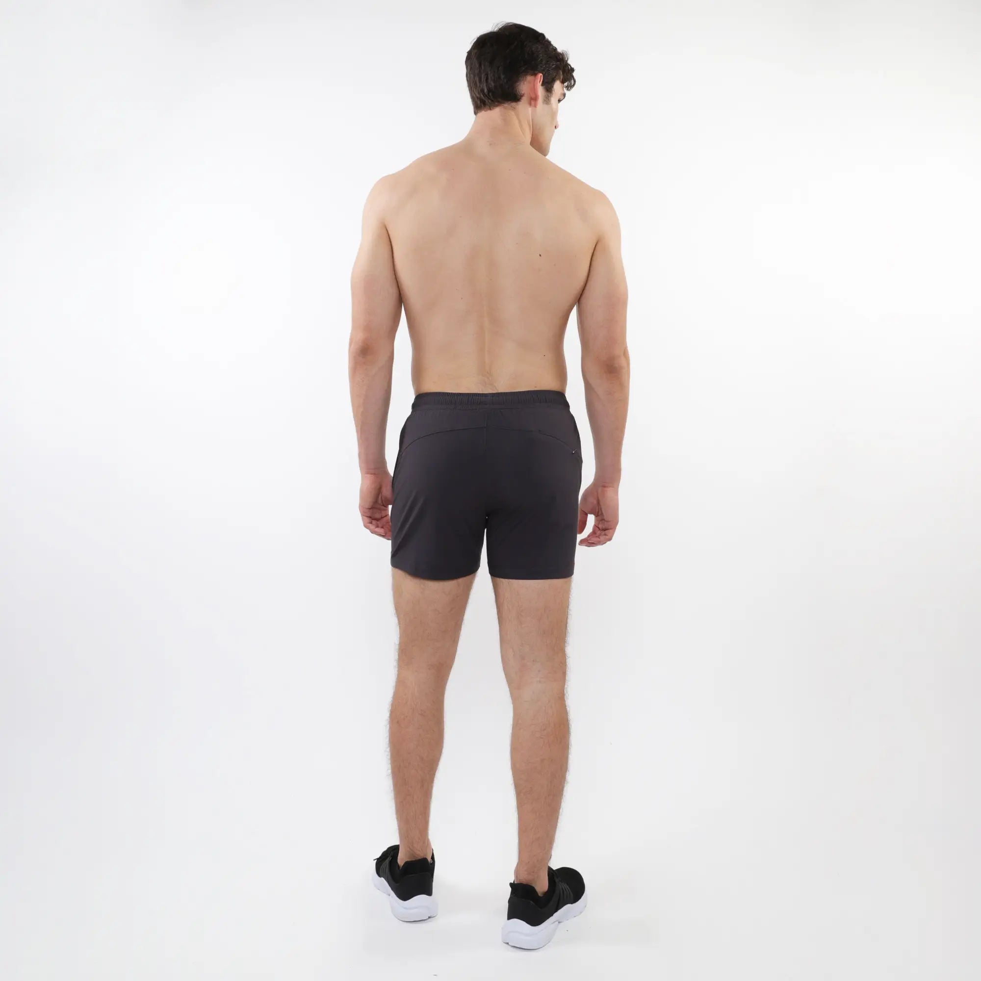 Black textured mesh stretch performance shorts with sleek form fitting design and subtle side pockets