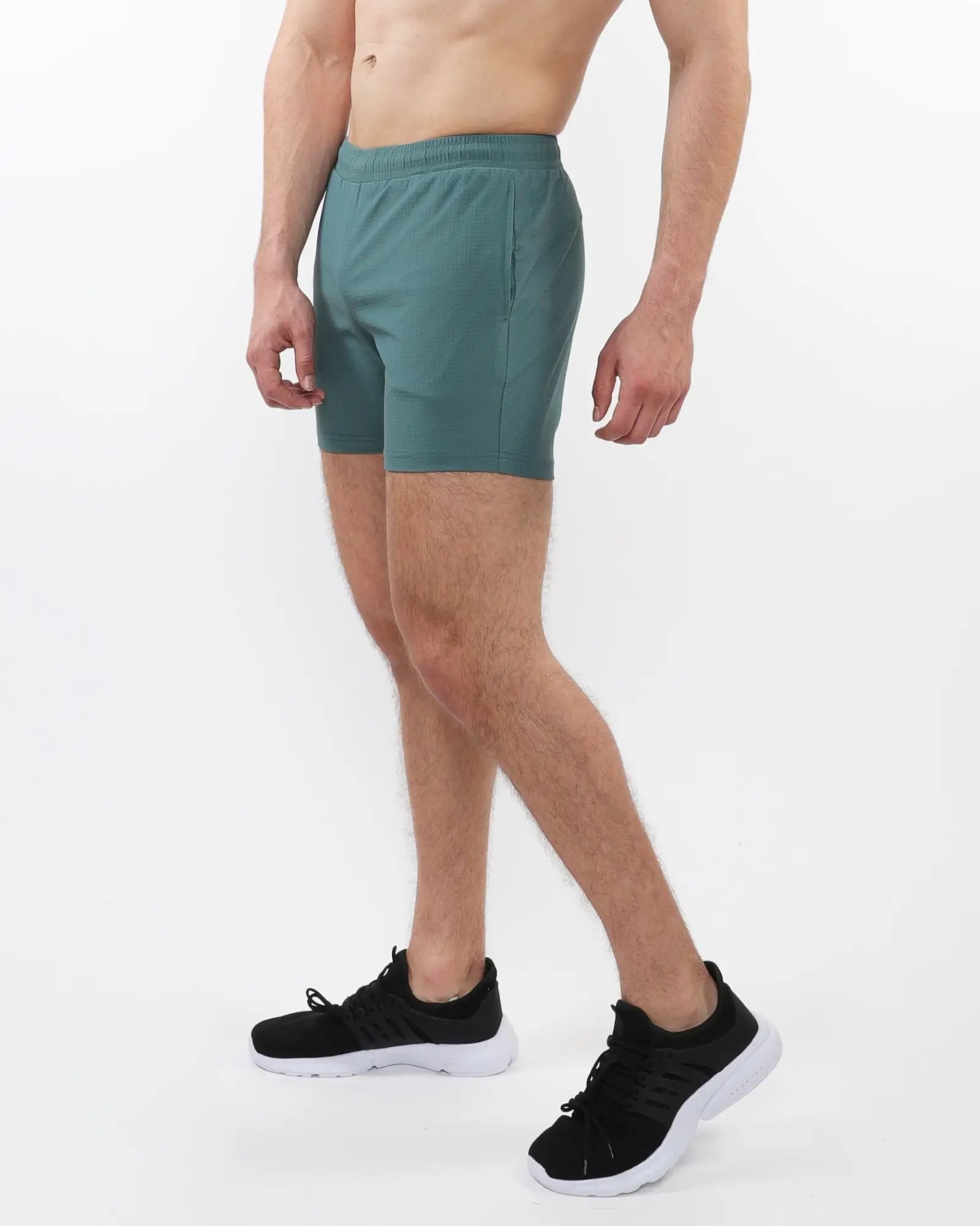 Teal textured mesh stretch performance shorts with elastic waistband and side pockets for athletic use