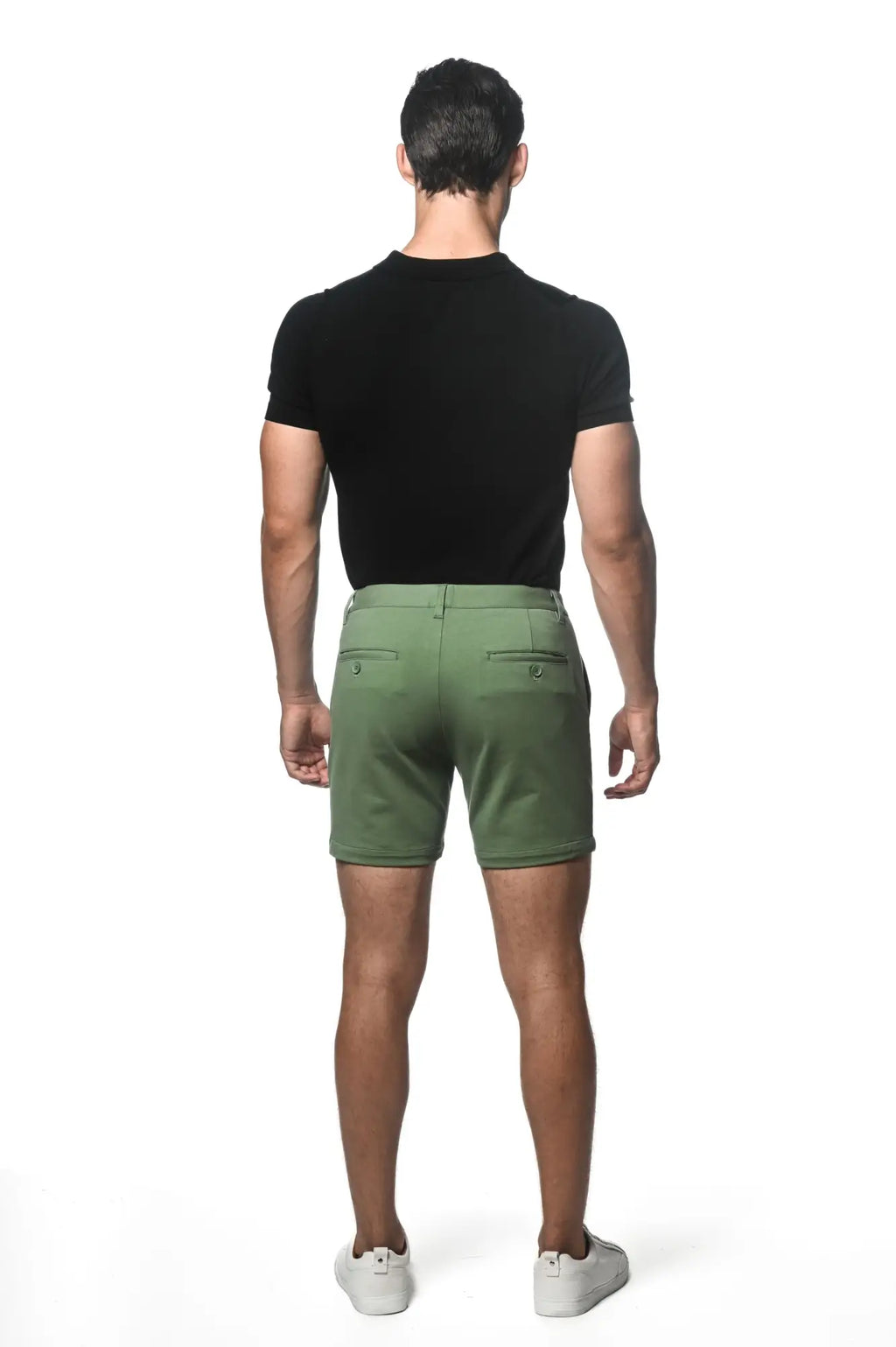 Olive green textured stretch knit chino shorts shown from the back with two buttoned back pockets