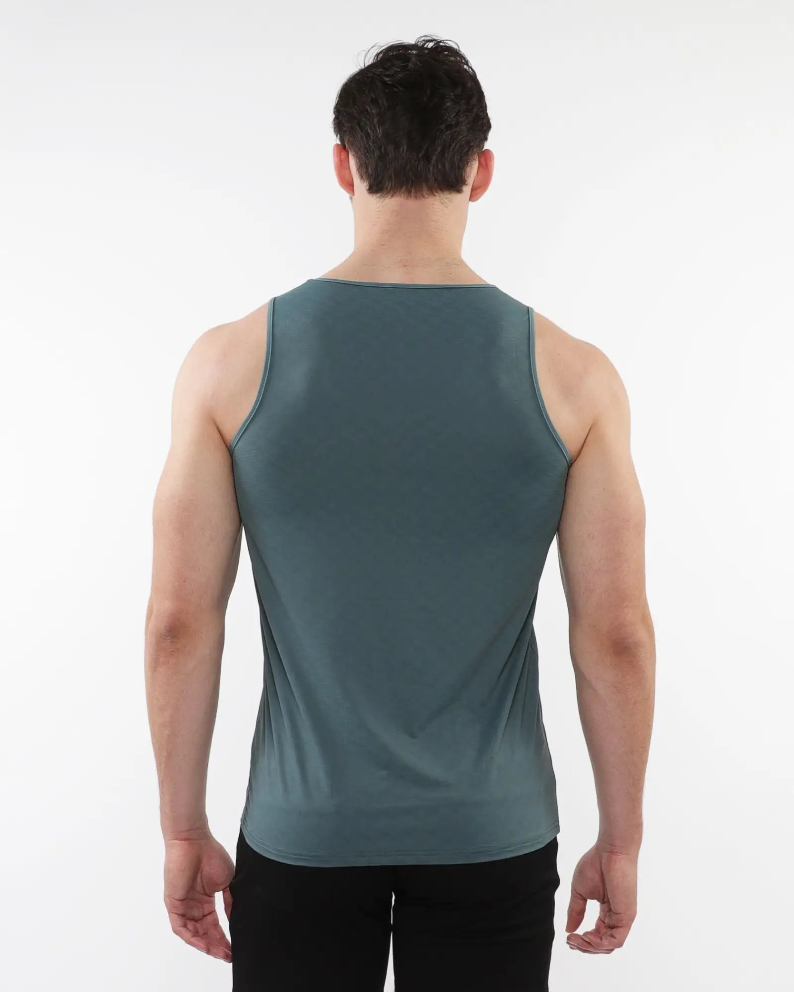 A sleek dark teal sleeveless tank top made of textured stretch mesh performance fabric for active wear