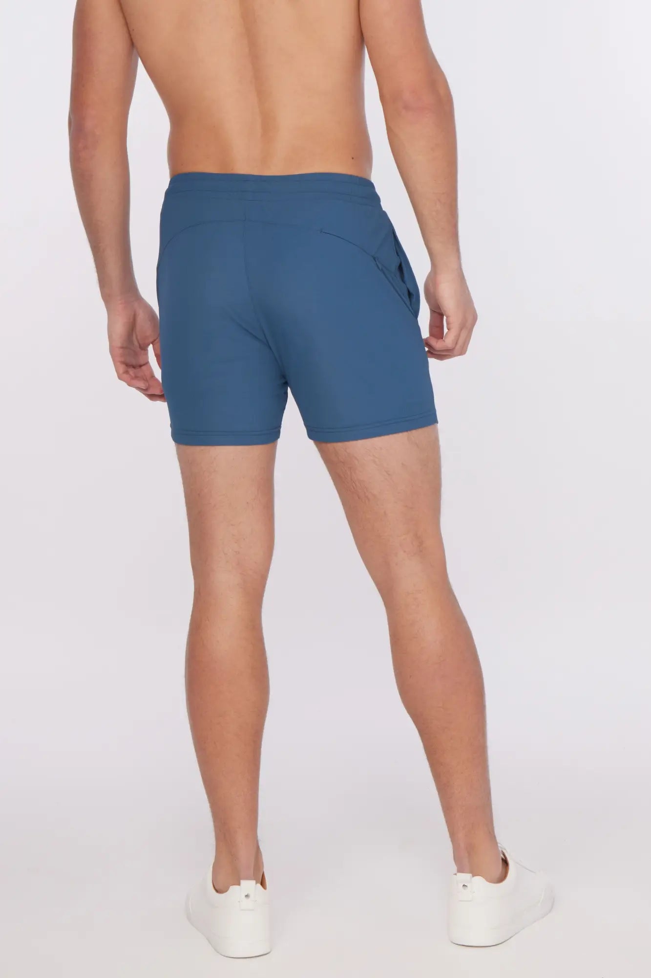 Blue textured stretch performance athletic shorts with sleek form-fitting design and subtle side pockets