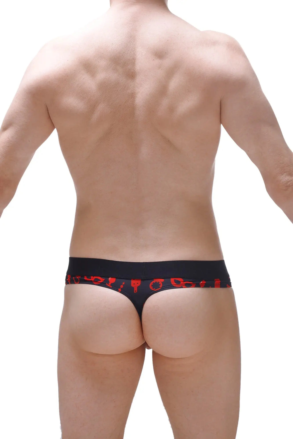 Black thong with red symbolic patterns along the waistband featuring an integrated cockring for boudoir use
