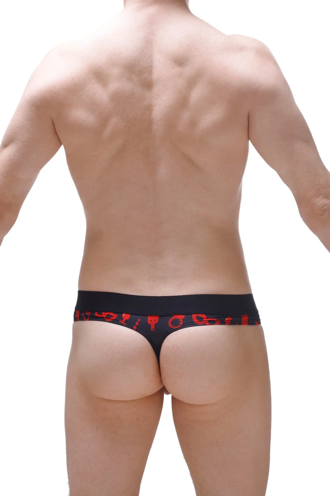 Black thong with red symbolic patterns along the waistband featuring an integrated cockring for boudoir use