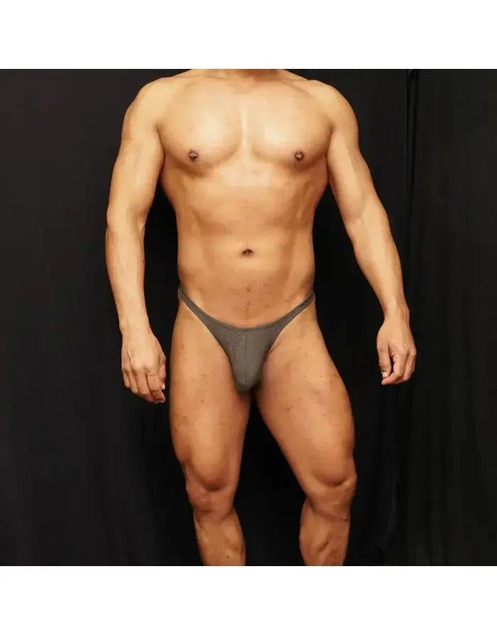 Moss green spandex thong by Arroyman featuring a sleek design and minimal coverage worn by a model.