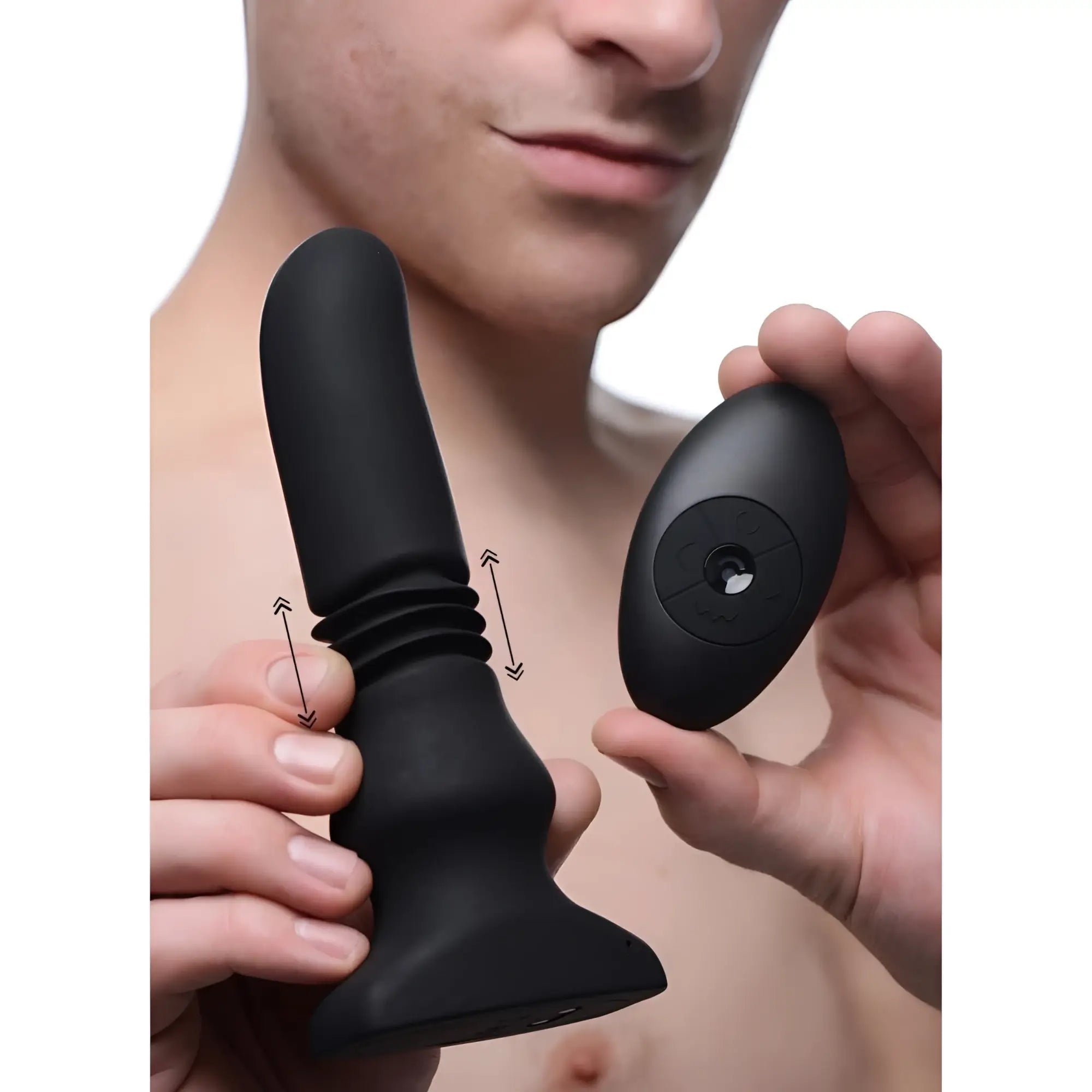 Thunderplugs black silicone vibrating/thrusting plug with matching remote, shown held by a person.