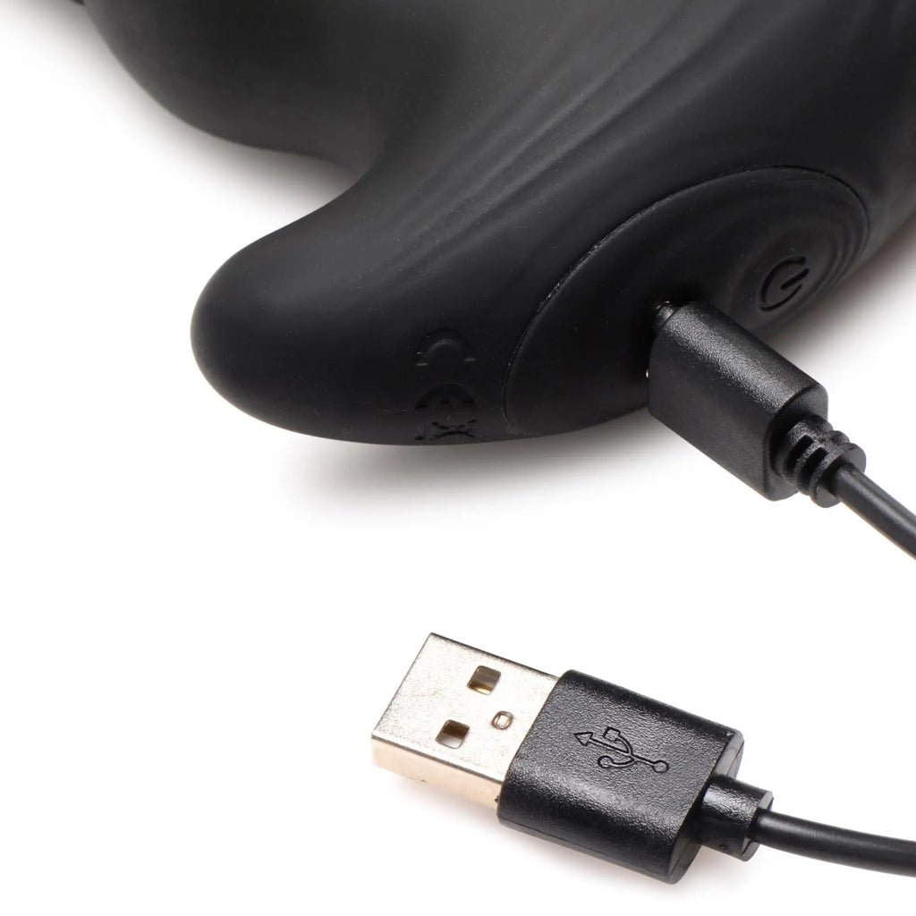 Black Thunderplugs thrusting vibrator with a power button and an attached USB charging cable on a white background.