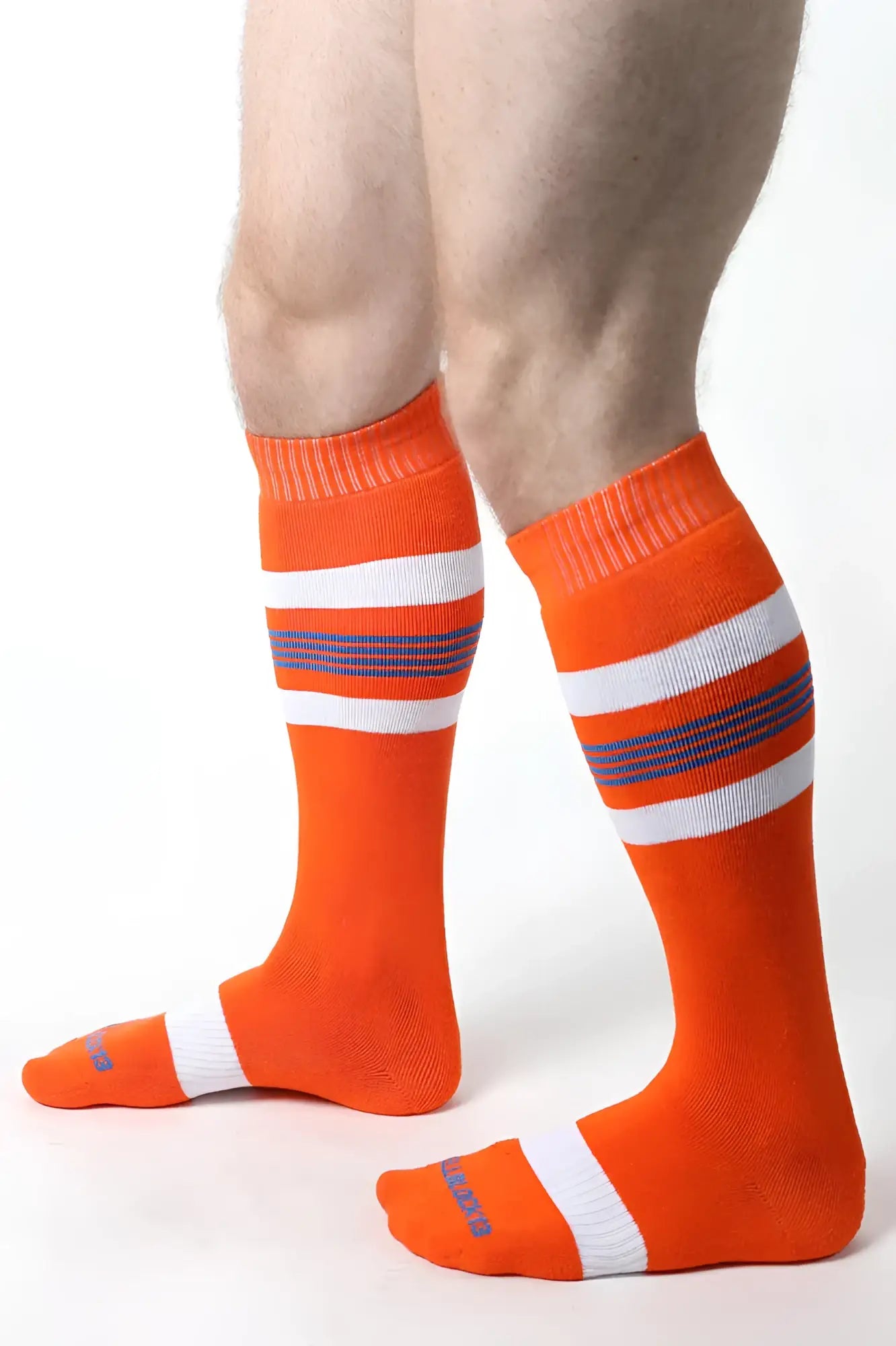 Bright orange tight end knee high socks with white and purple stripes featuring ribbed cuff and toe design