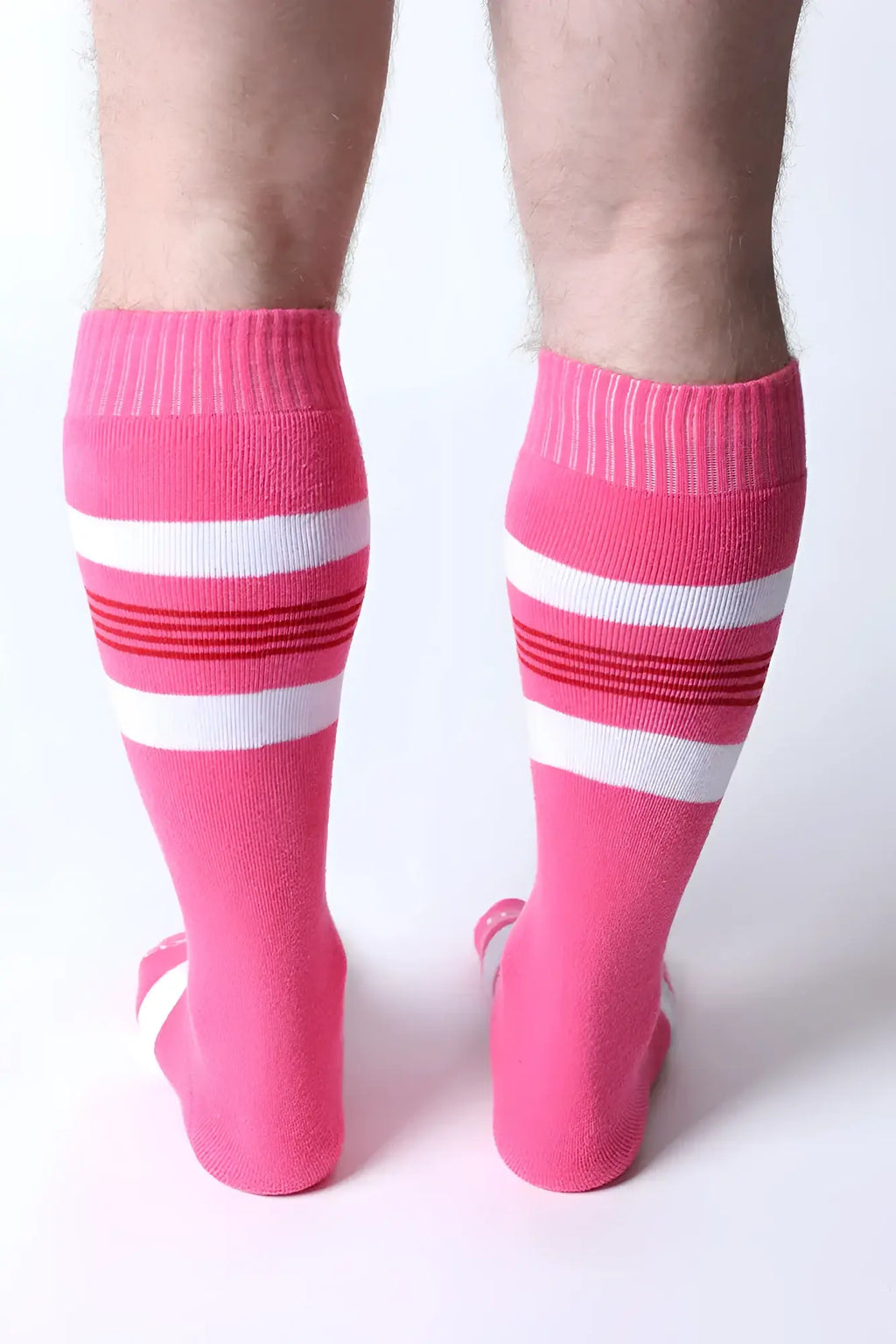 Bright pink tight end knee high socks with white and red striped bands perfect for athletic wear