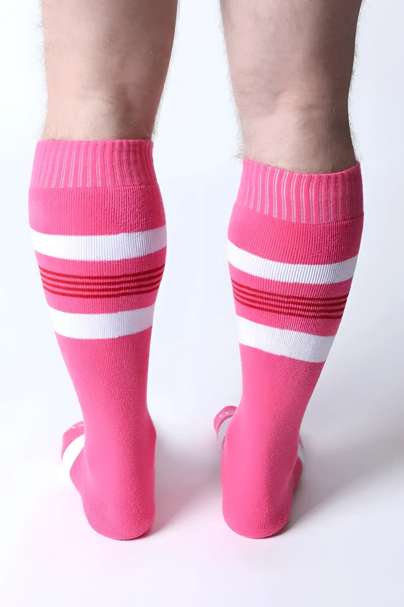 Bright pink tight end knee high socks with white and red striped bands perfect for athletic wear