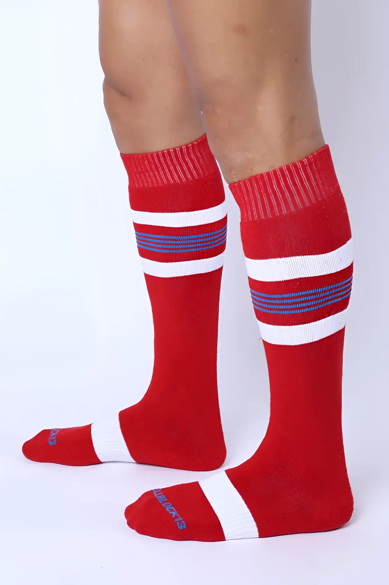 Tight end knee high socks in red with white and navy stripes featuring ribbed cuff and toe for athletic wear