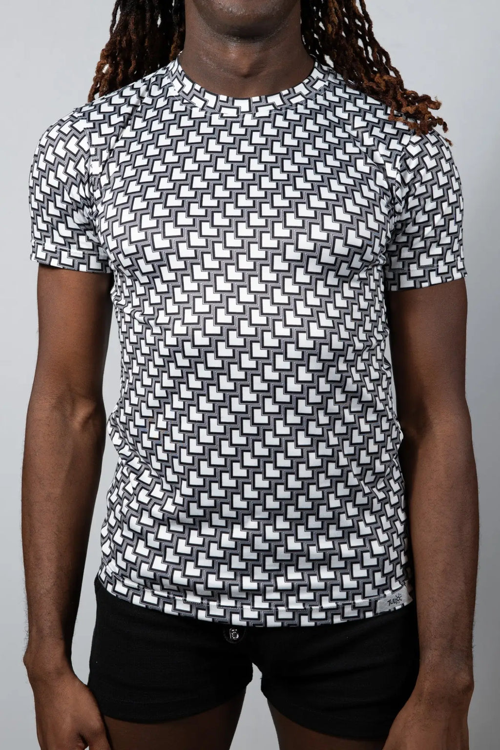 Black and white geometric patterned short sleeve rash guard tile print tee for sun protection and active wear